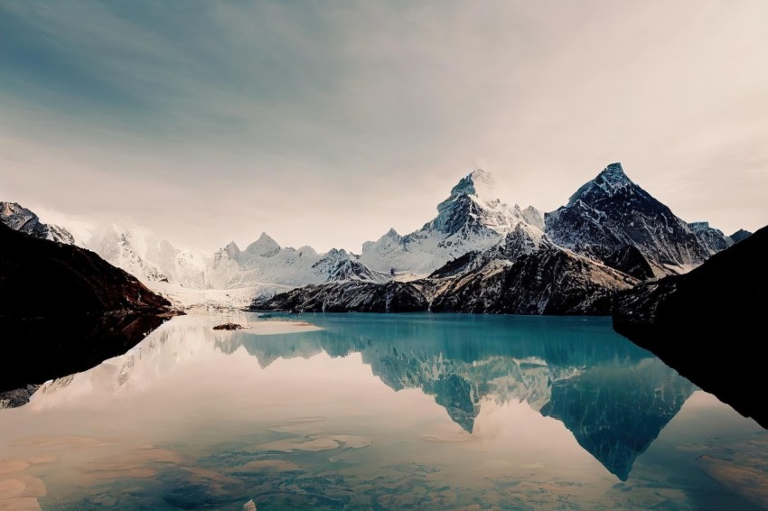 Surreal Architectural Landscapes: Serene Lake with Snow-Capped Mountains